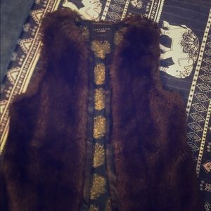 Faux fur vest with black leather trim